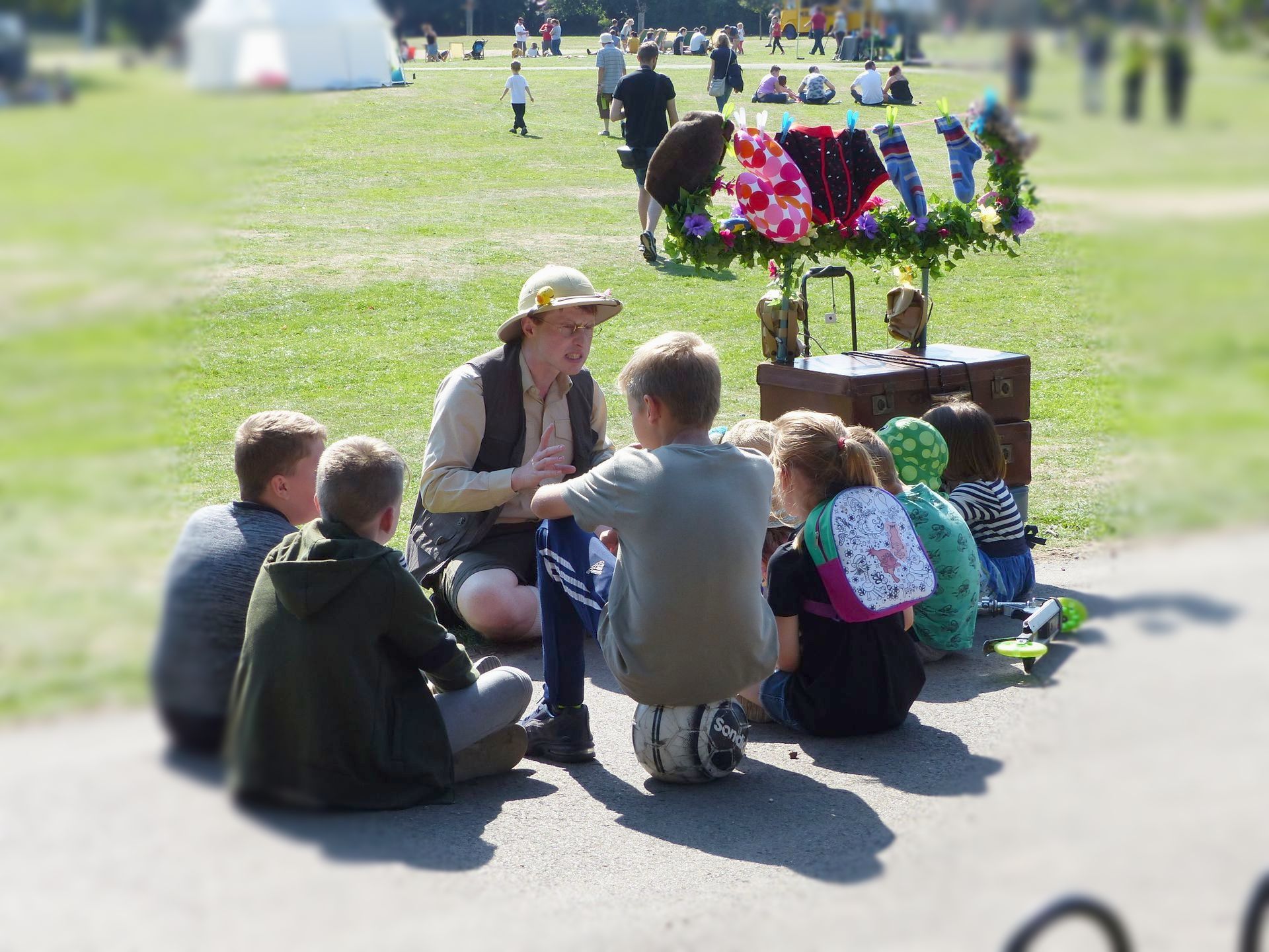 Prof. Mappington sits telling a story to an audience of young people.