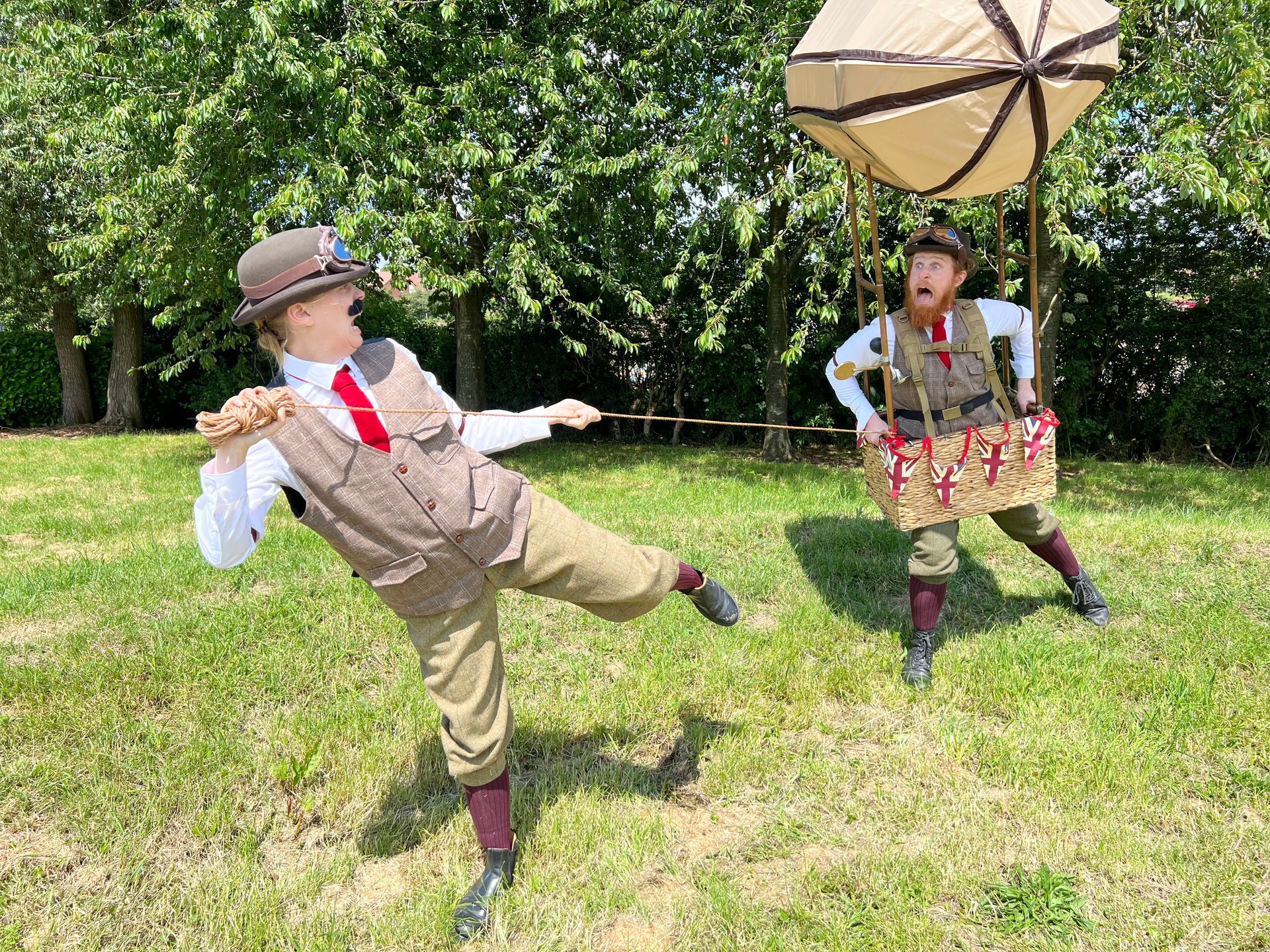 The Wrong Brothers walkabout street theatre act posing with their eye-catching flying the person airship contraction