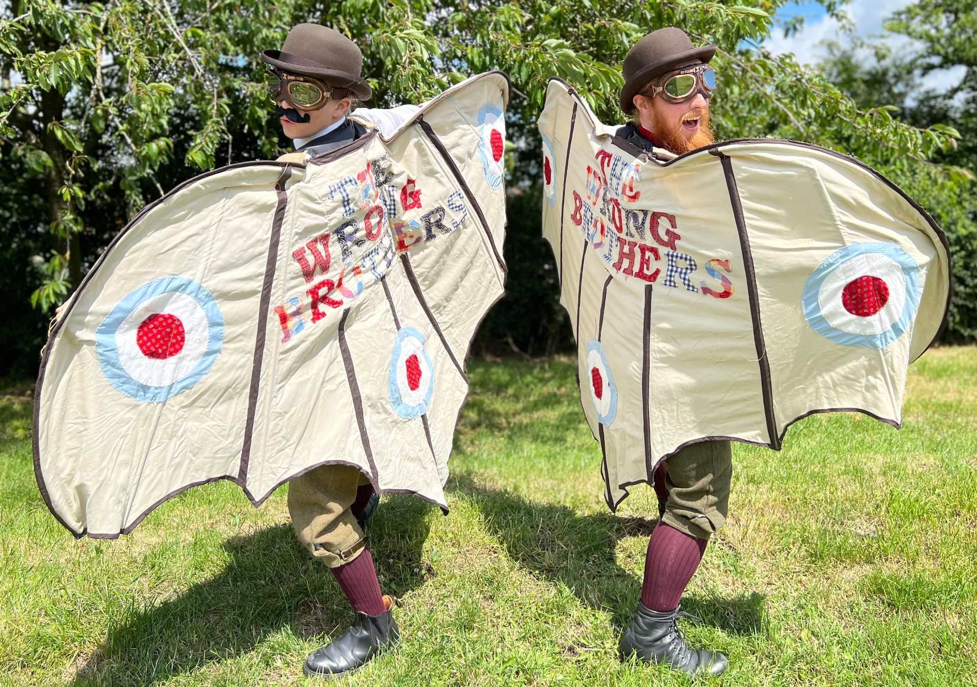 The Wrong Brothers walkabout street theatre act posing with their eye-catching flying machine wingsuits 