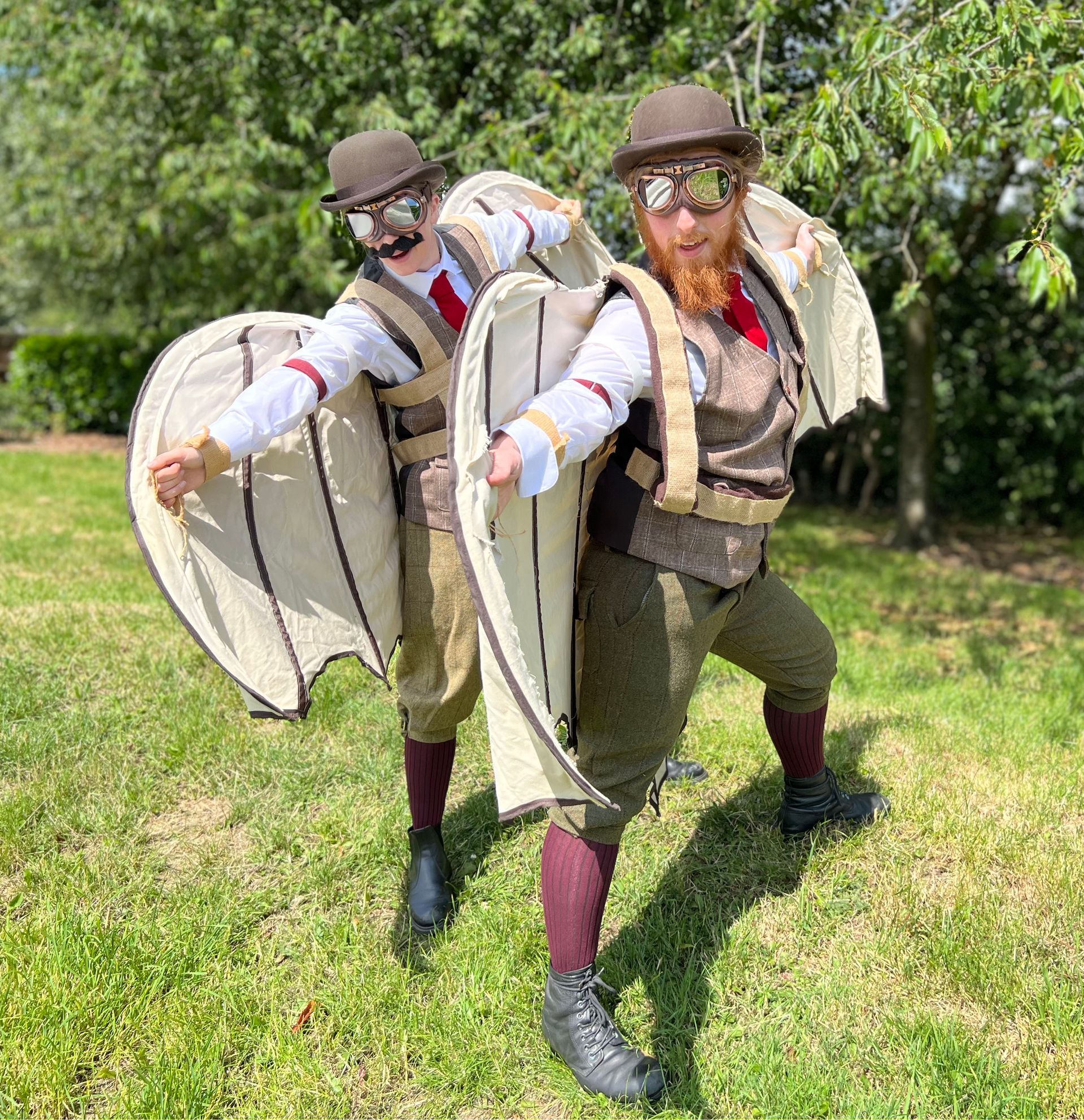 The Wrong Brothers walkabout street theatre act posing with their eye-catching flying machine wingsuits 