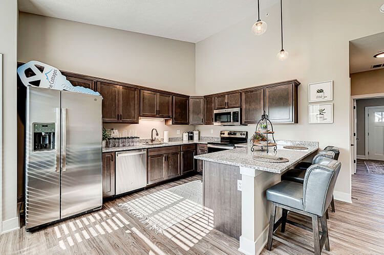 A kitchen with stainless steel appliances and wooden cabinets.
