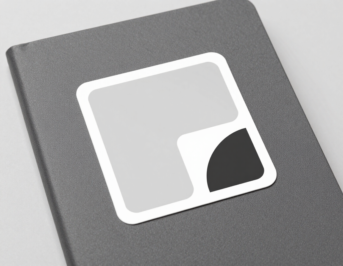 Matte sticker on notebook cover — clean minimal branding