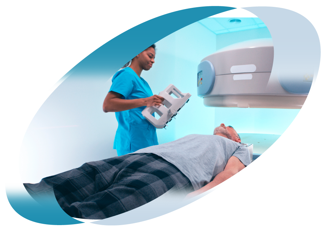 A man is getting an mri scan in a hospital while a nurse looks on.