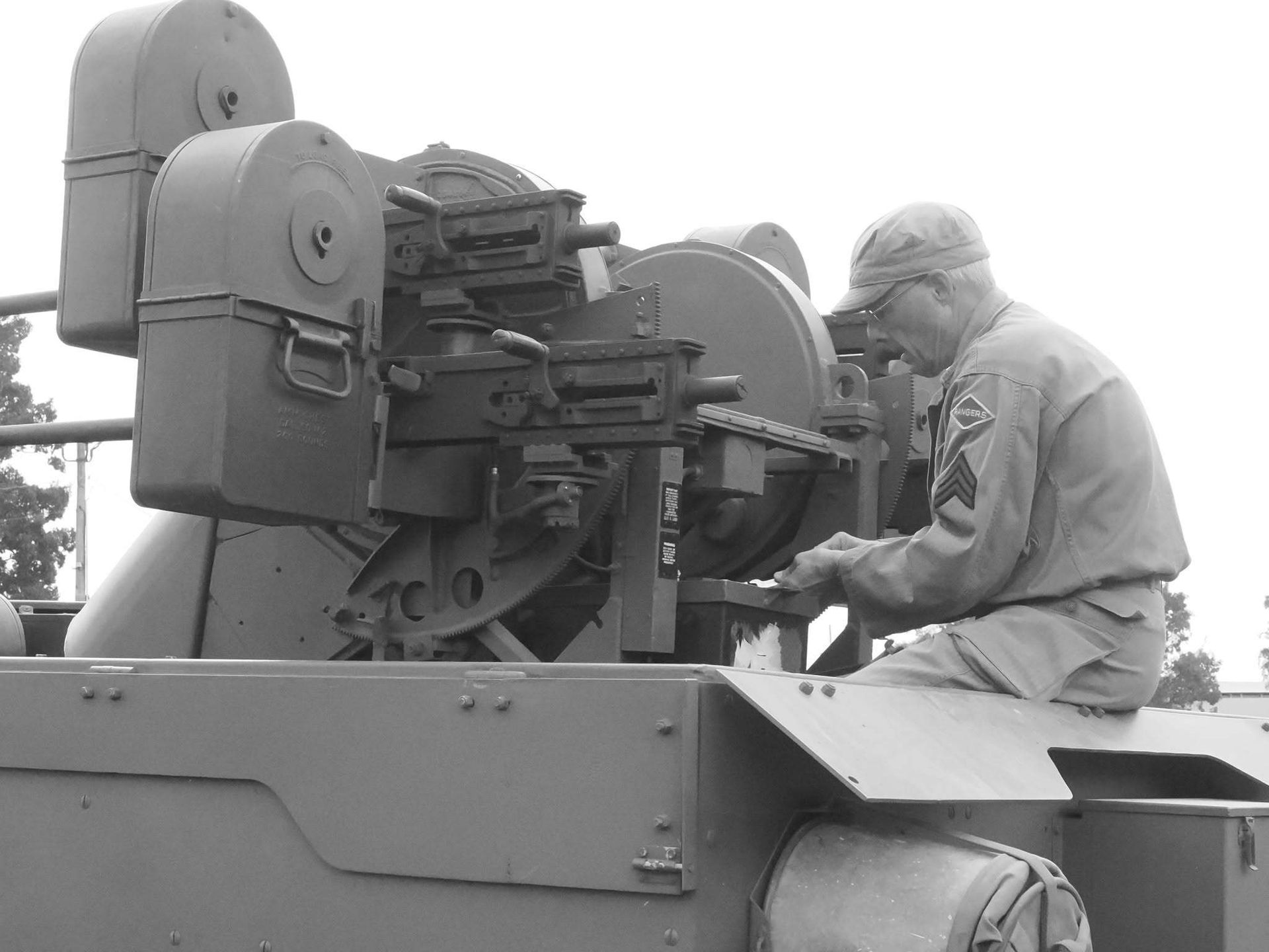 Soldier operating a mounted machine gun on a military vehicle