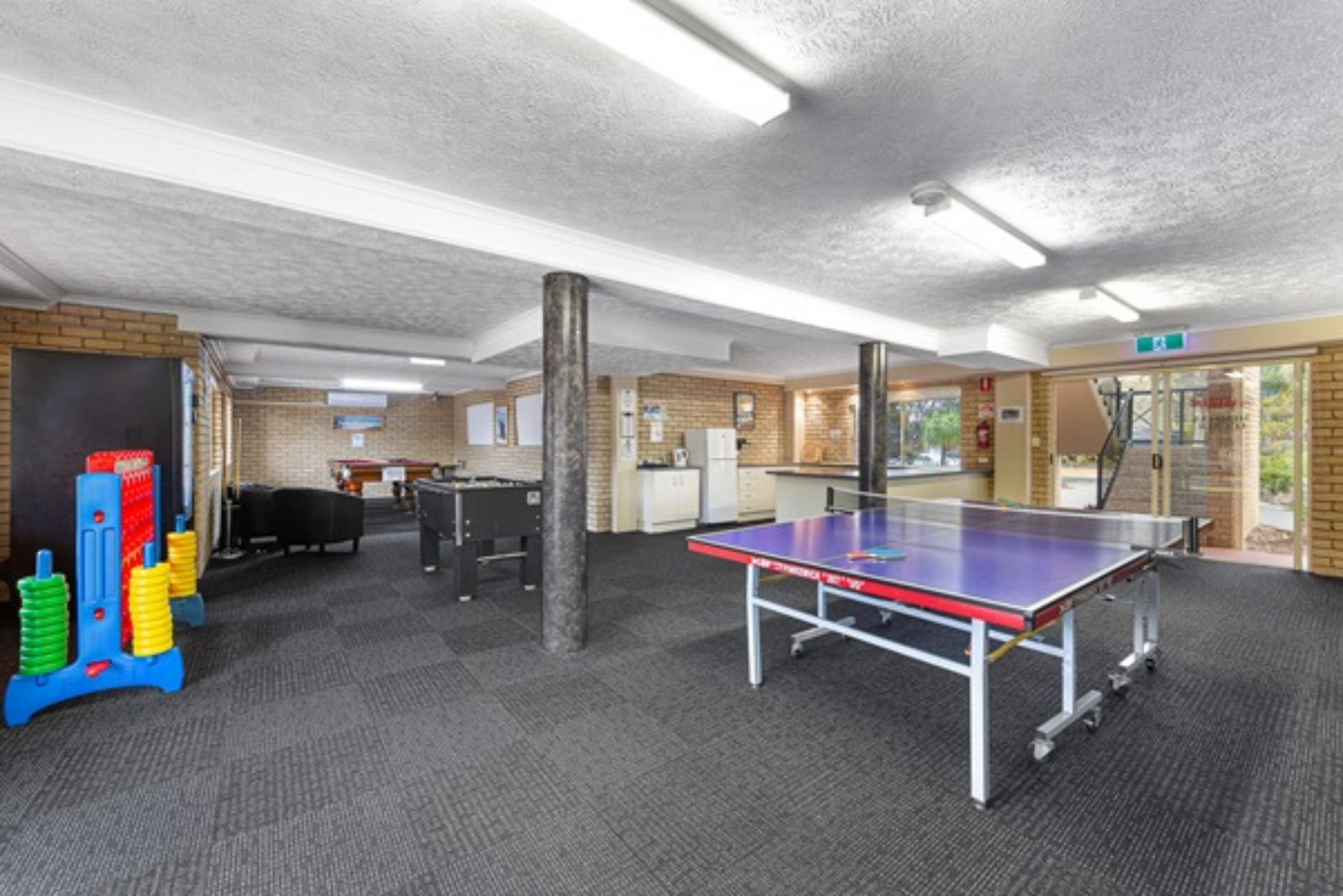 There is a ping pong table in the middle of the room.