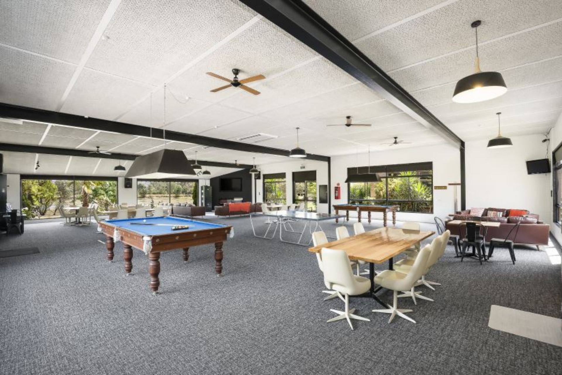 There is a pool table in the middle of the room.