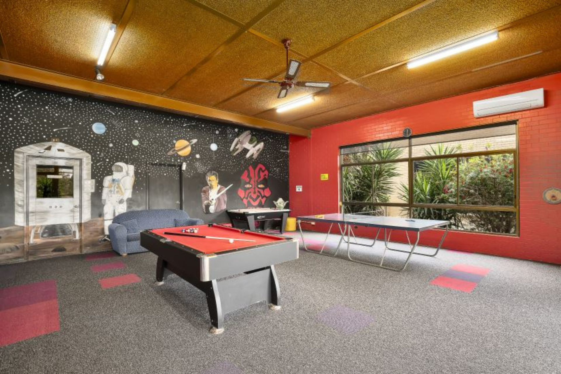 There is a pool table in the middle of the room.