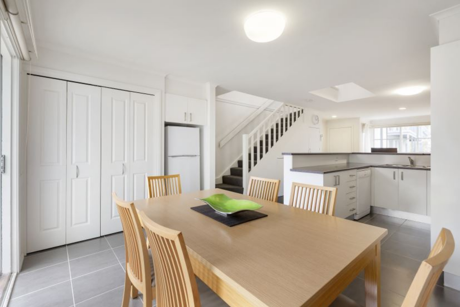 A dining room with a table and chairs in a house
