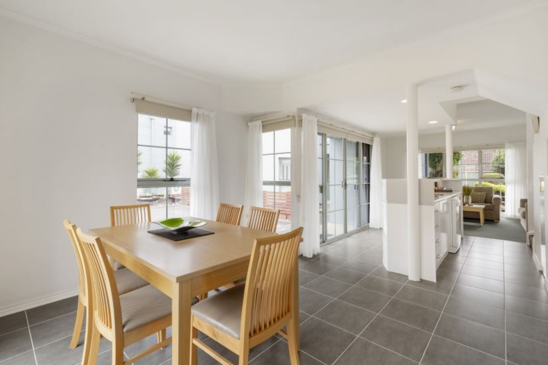 A dining room with a wooden table and chairs