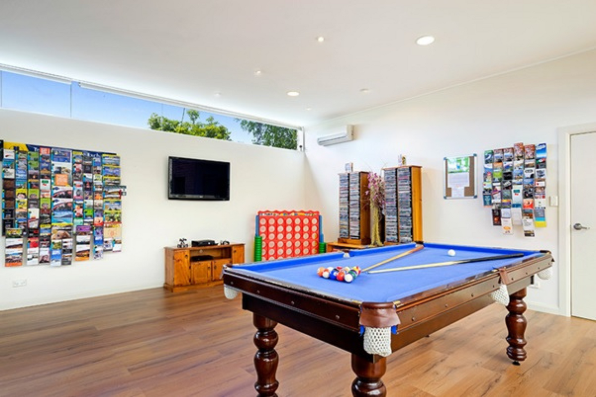 There is a pool table in the middle of the room.