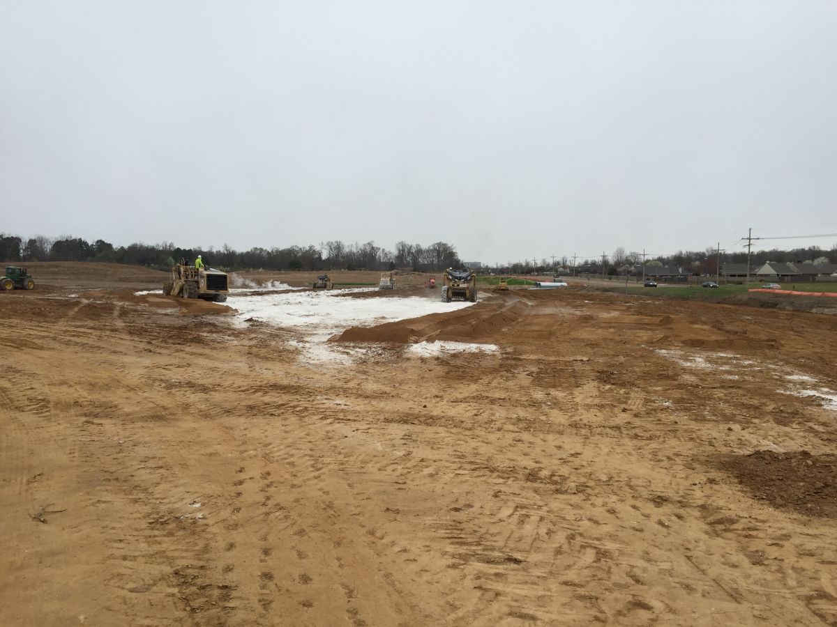 A construction site with a lot of dirt and snow on the ground.