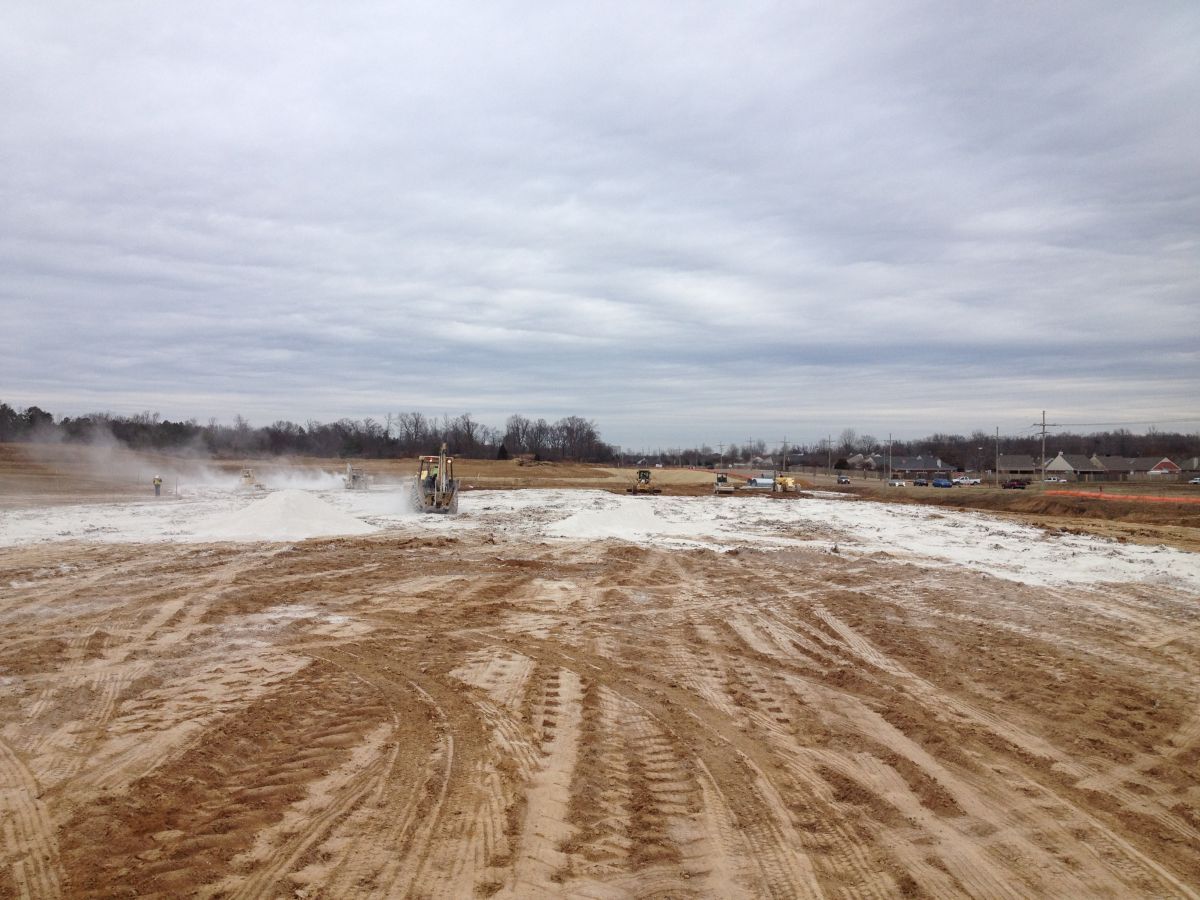 A large dirt field with a lot of tracks in it.