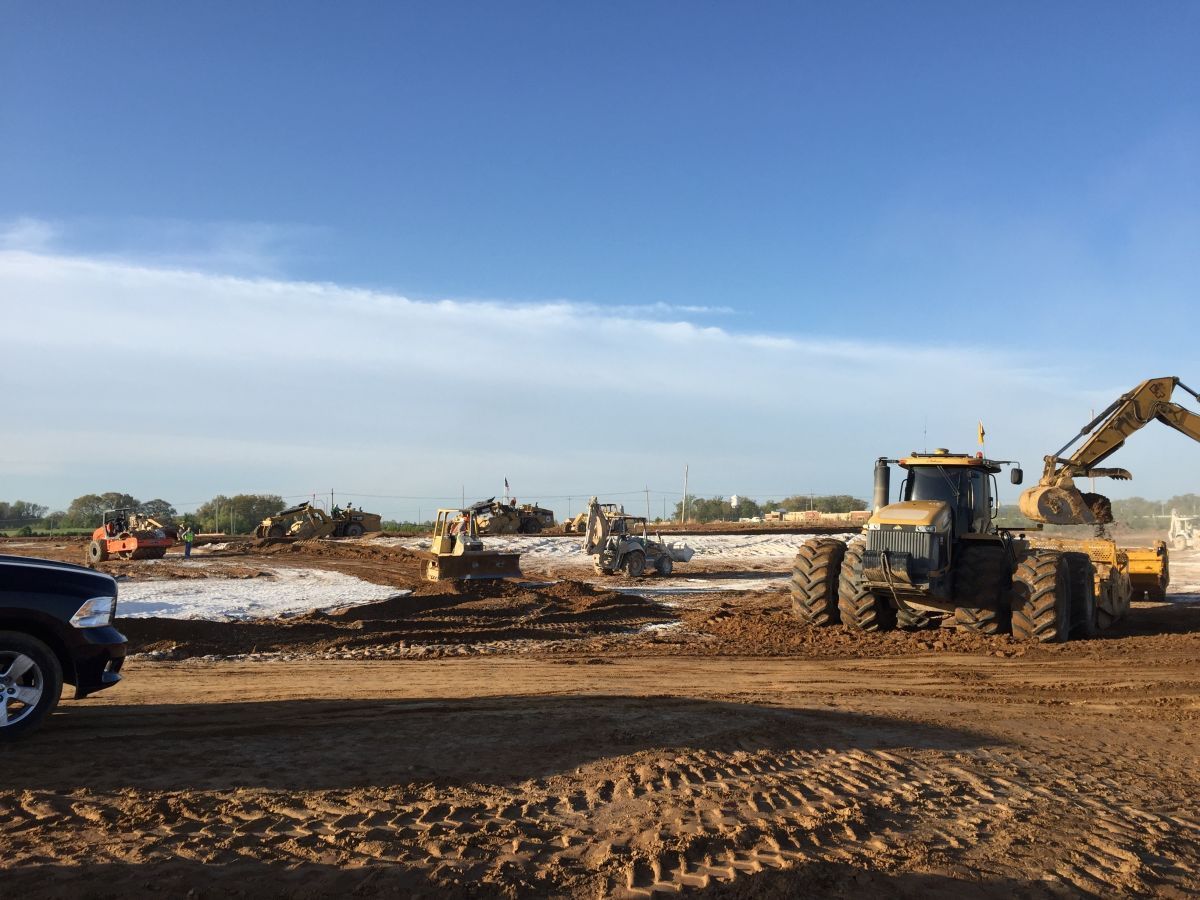 A black truck is parked in front of a construction site.