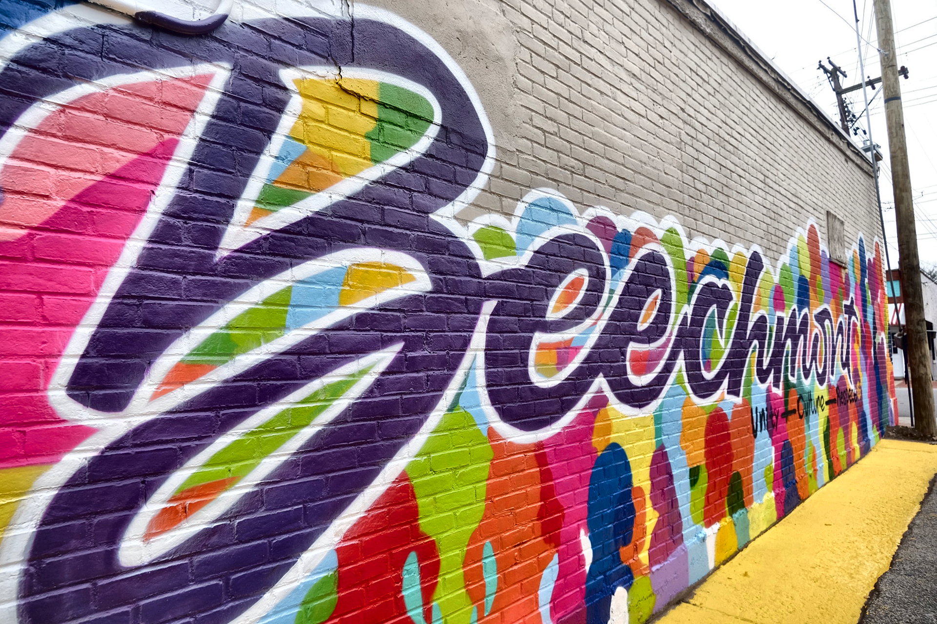 Colorful mural on brick wall: