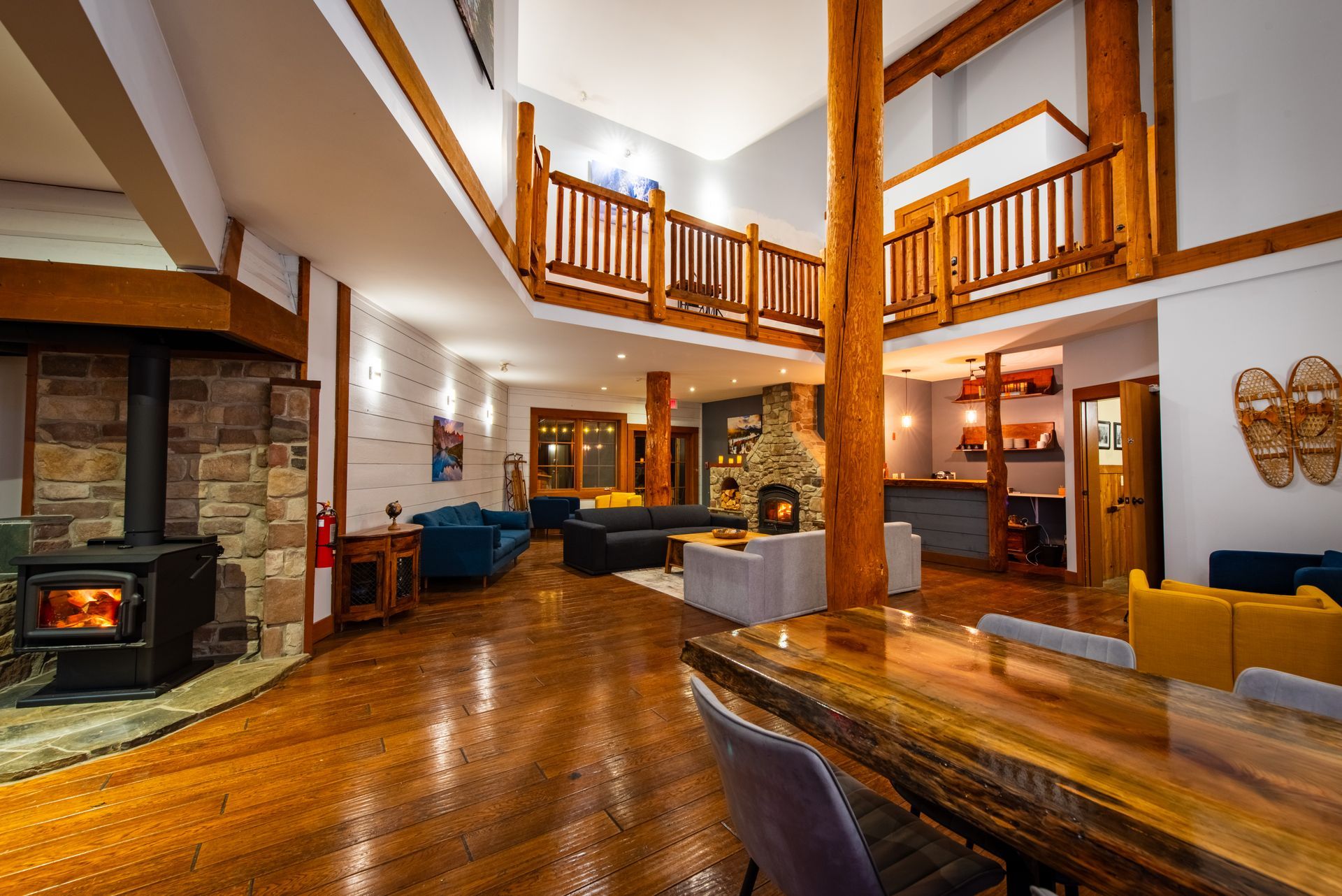 A large living room with hardwood floors and a wood stove.