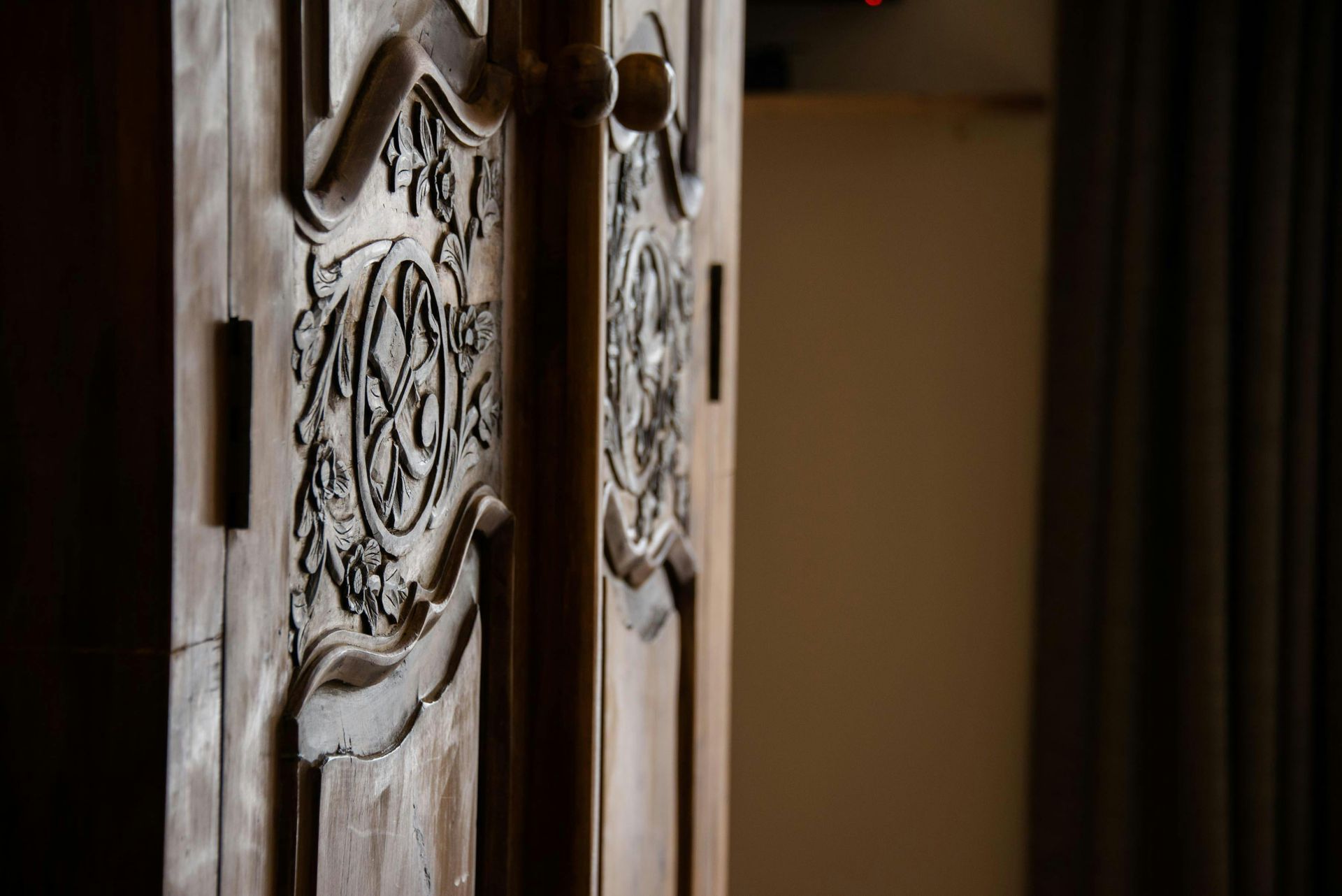 A close up of a wooden door with a carving on it.