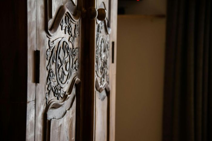 A close up of a wooden door with a carving on it.