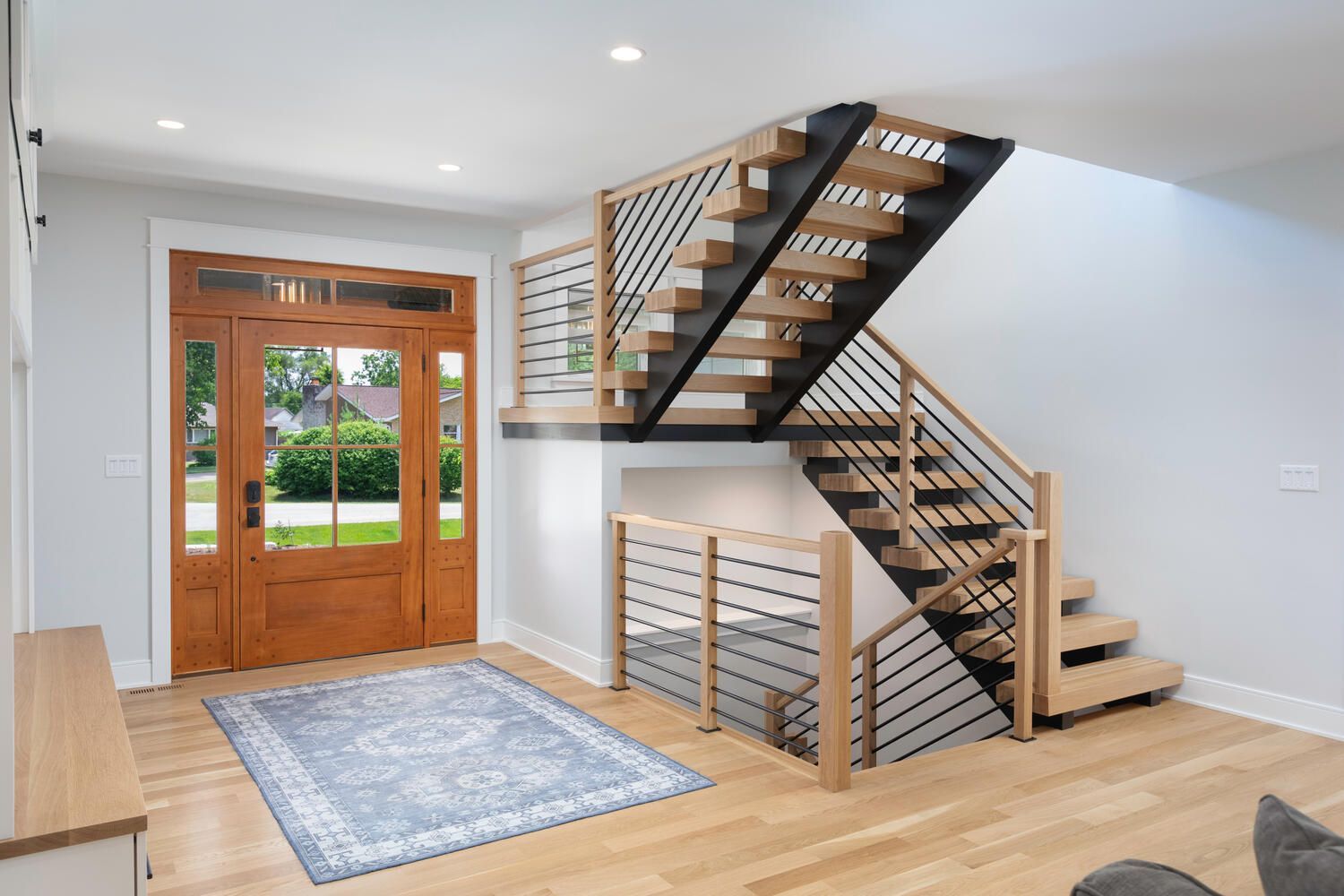 Custom home staircase, front door, entryway. Chicago suburbs Plainfield, Hinsdale, Elmhurst, Naperville, Illinois.