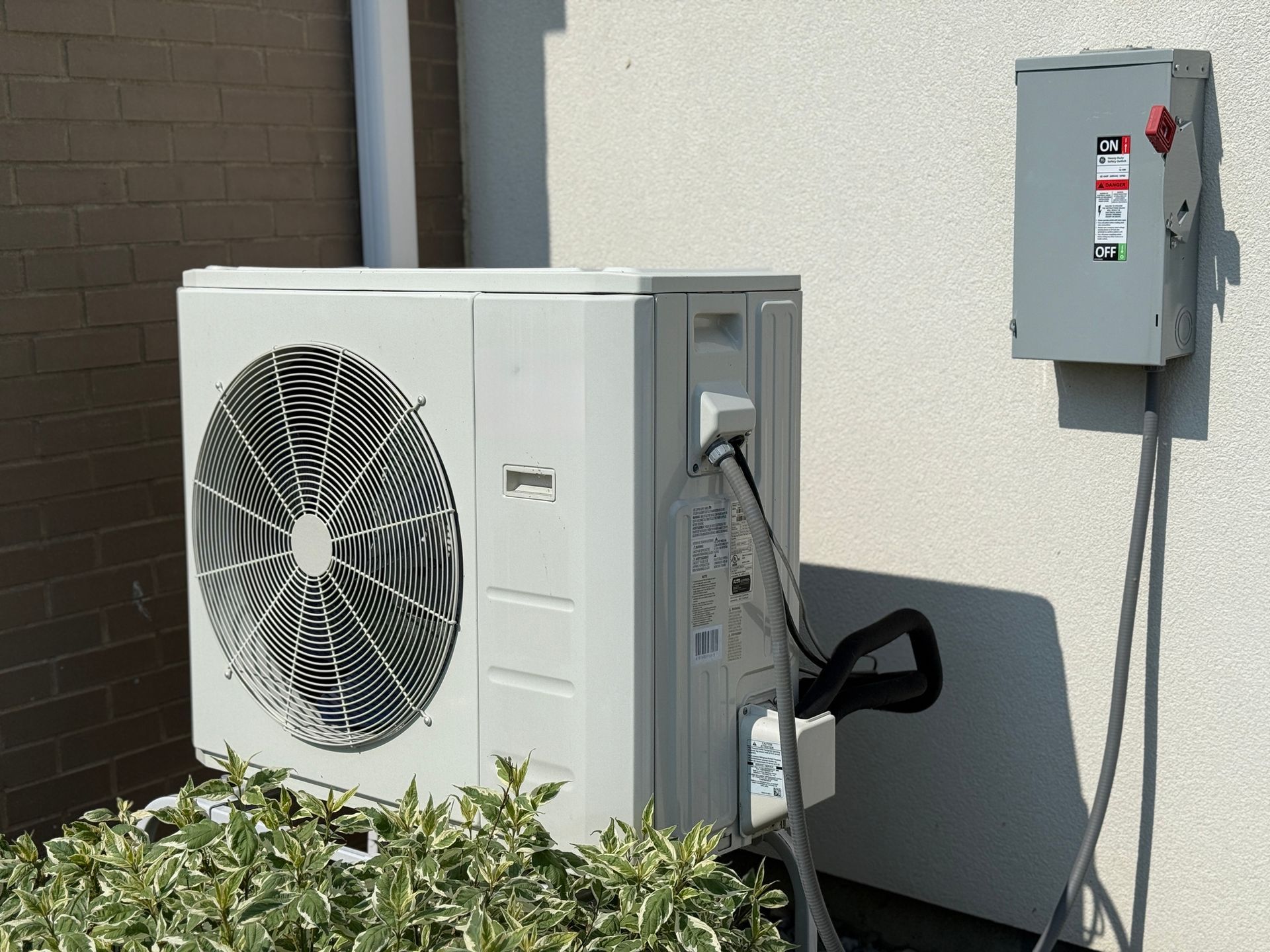 Heat pump outdoor unit providing efficient summer cooling for a home in Clearwater, Florida.