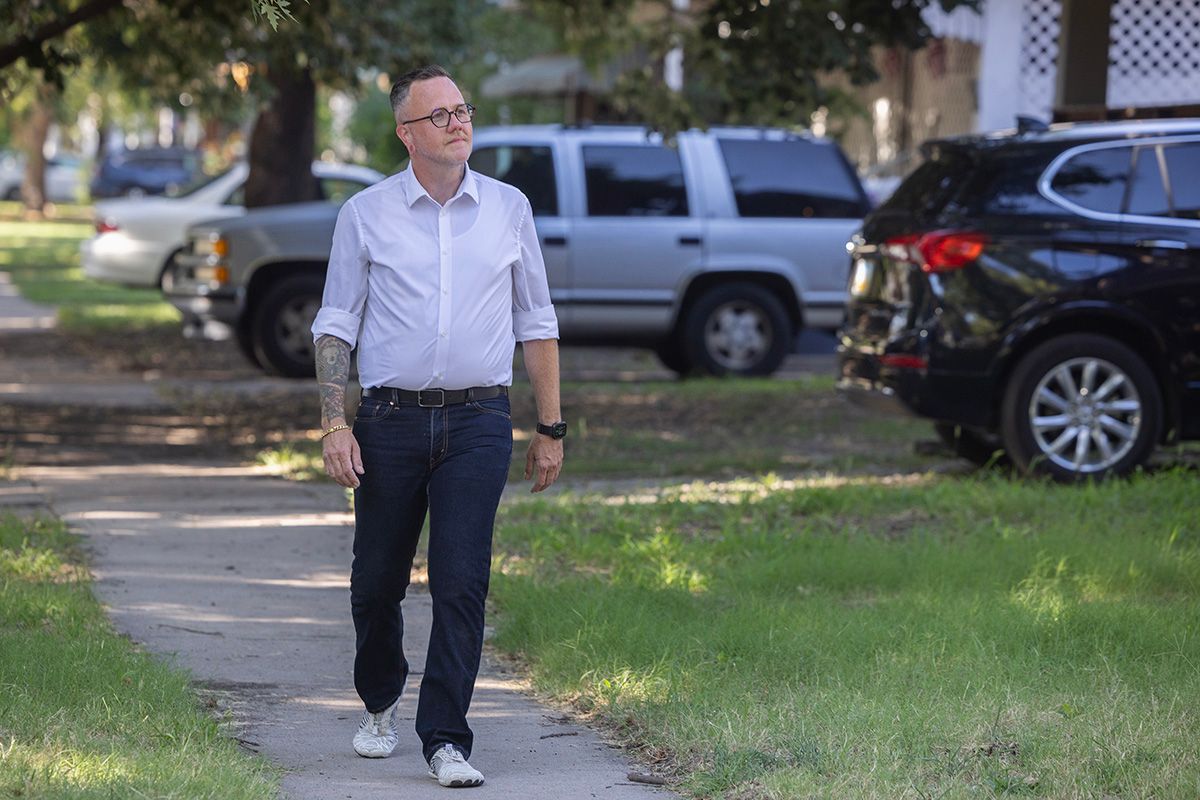 Senator Silas Miller walking a neighborhood sidewalk in District 25