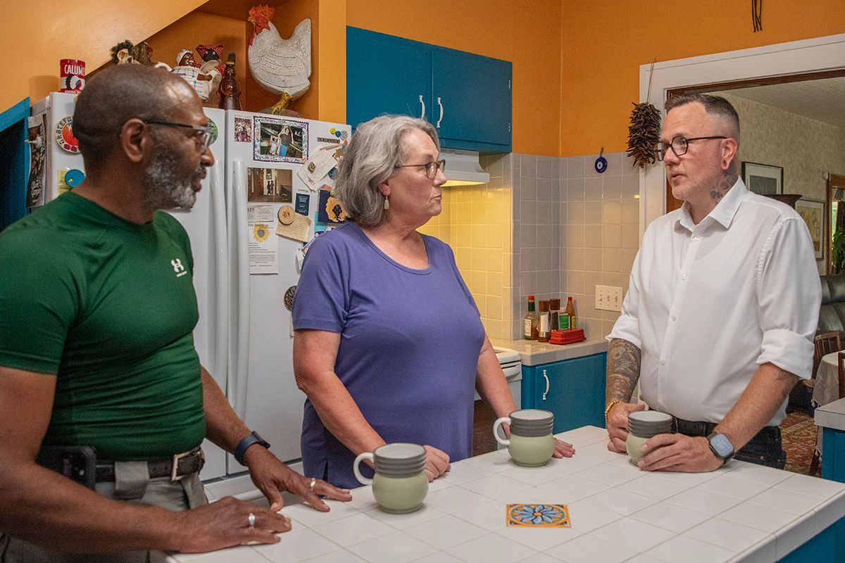 Senator Silas Miller talking with constituents at their kitchen table