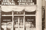 Storefront sign for Geo. A. Jenkins Funeral Director, with undertaker and embalmer offices visible
