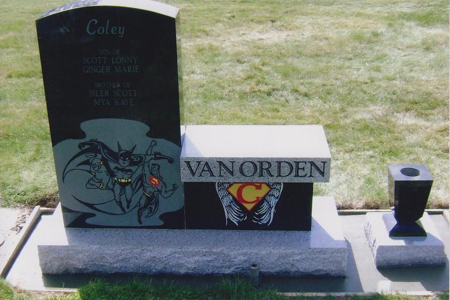 Gravestone in a cemetery with “VAN ORDEN” engraved on the base and a small flower vase nearby