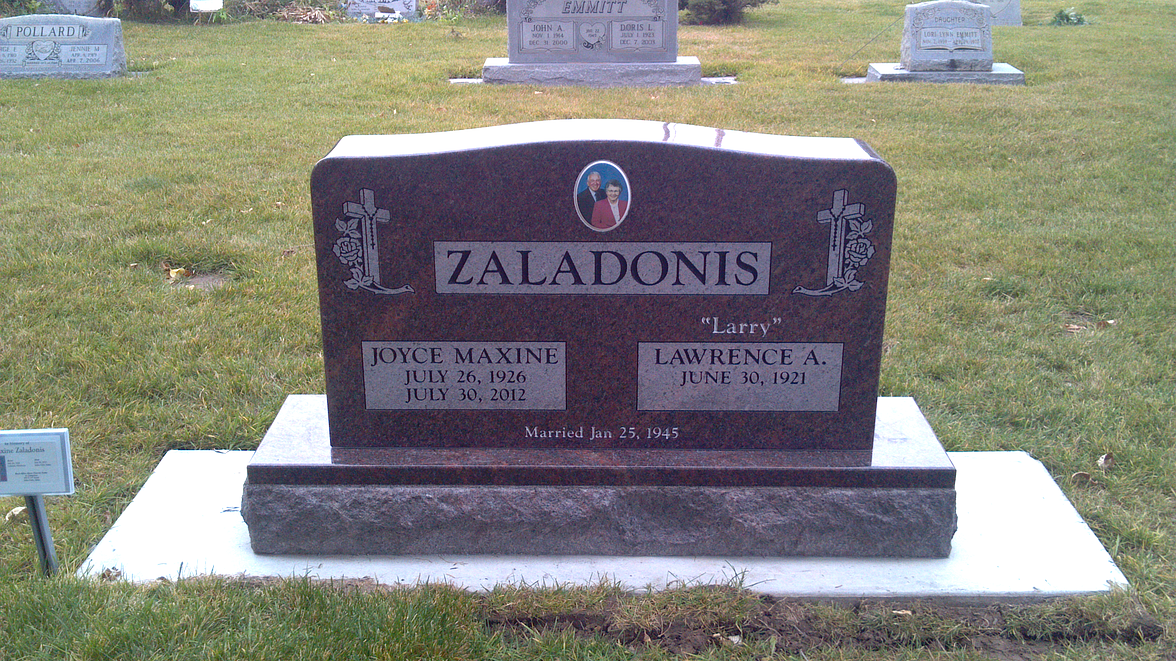 Zaladonis family gravestone with engraved plaques in a grassy cemetery