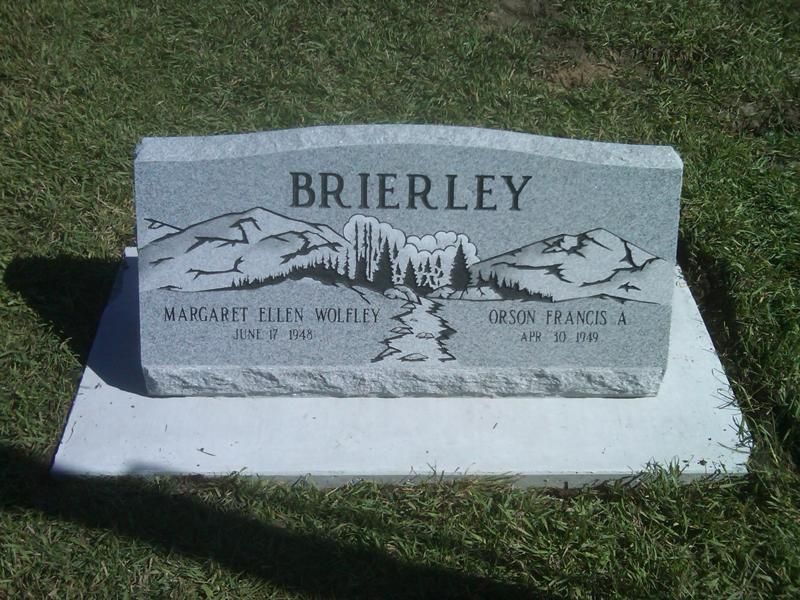Brierley family gravestone with mountain engraving on a grassy lawn