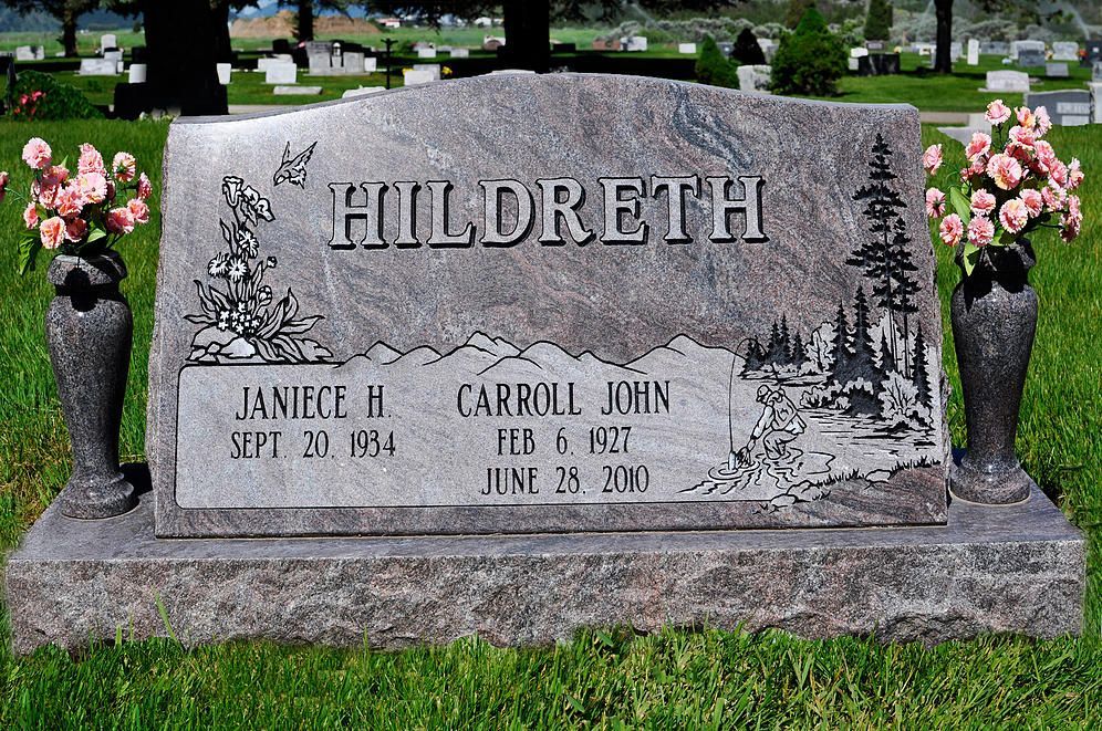 Hildreth family gravestone with pink flowers on both sides in a cemetery