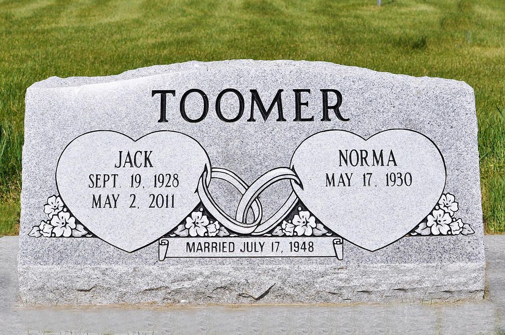 Toomer family gravestone with heart-shaped plaques for Jack and Norma in a cemetery