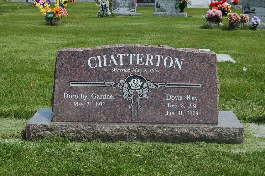 Chatteton granite gravestone on a green lawn with flowers in the background