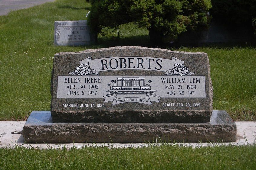Roberts gravestone in a grassy cemetery, with engraved names and dates on a gray stone marker