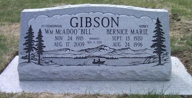 Gray Gibson family gravestone with engraved trees and two memorial plaques in a cemetery