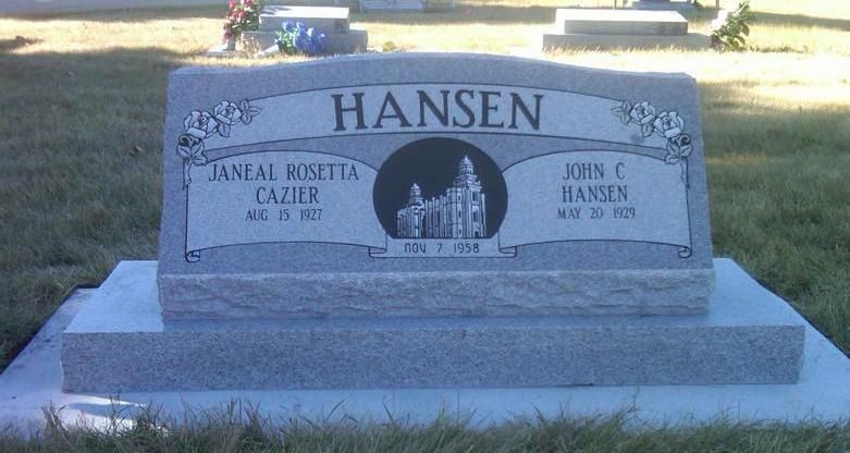 Gray gravestone with engraved names and a small church silhouette, set on a grassy lawn.