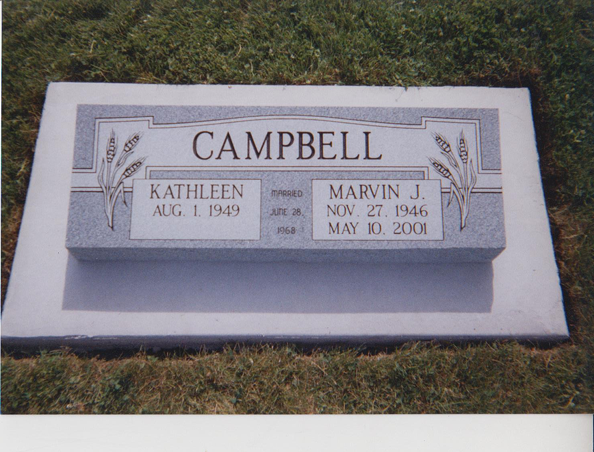 Campbell grave marker with engraved names Kathleen and Marvin J., on a gray memorial stone