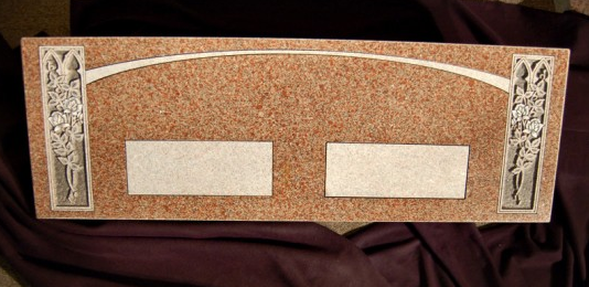 Wooden plaque with decorative silver corners and two blank nameplates on a corkboard background