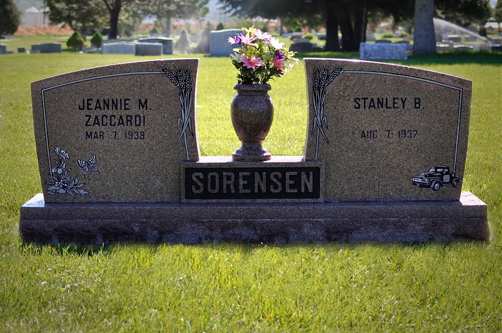 Two engraved gravestones with flowers on a cemetery base labeled Sorensen