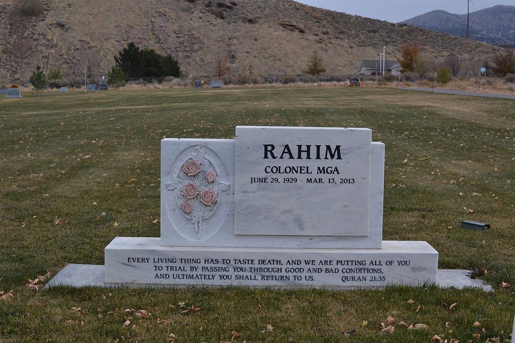 Gravestone for Rahim in a grassy cemetery with mountains in the background