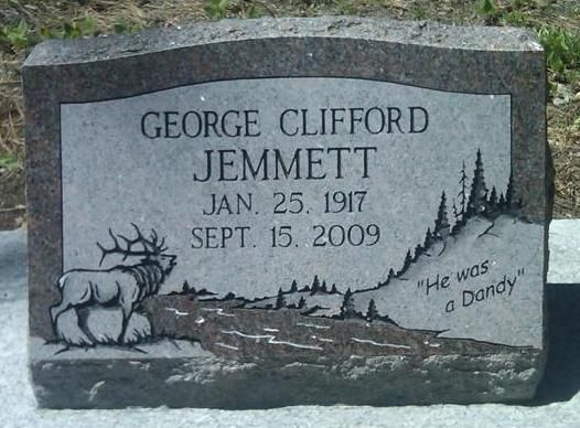 Headstone for George Clifford Jemmett, Jan. 25, 1917–Sept. 15, 2009, with carved moose and trees.