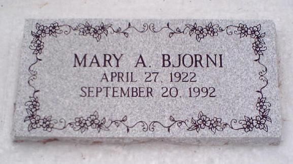 Marble gravestone with floral border reading “Mary A. Bjorni,” April 27, 1922–September 20, 1992