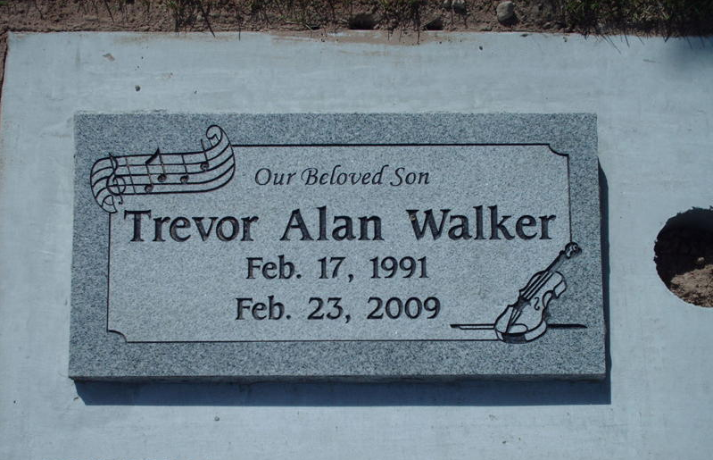 Gravestone plaque for Trevor Alan Walker with music notes and violin engraving, dated Feb. 17, 1991–Feb. 23, 2009