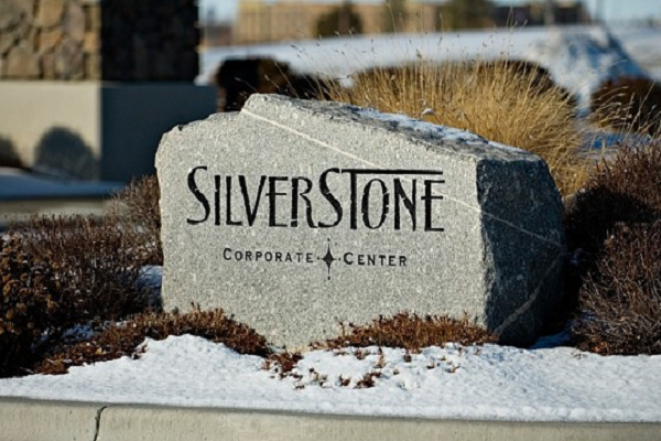 Stone sign reading “Silverstone Corporate Center” in a snowy landscape