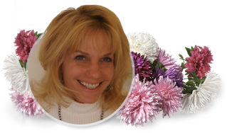 Smiling blonde woman framed by pink and white flowers on a white background