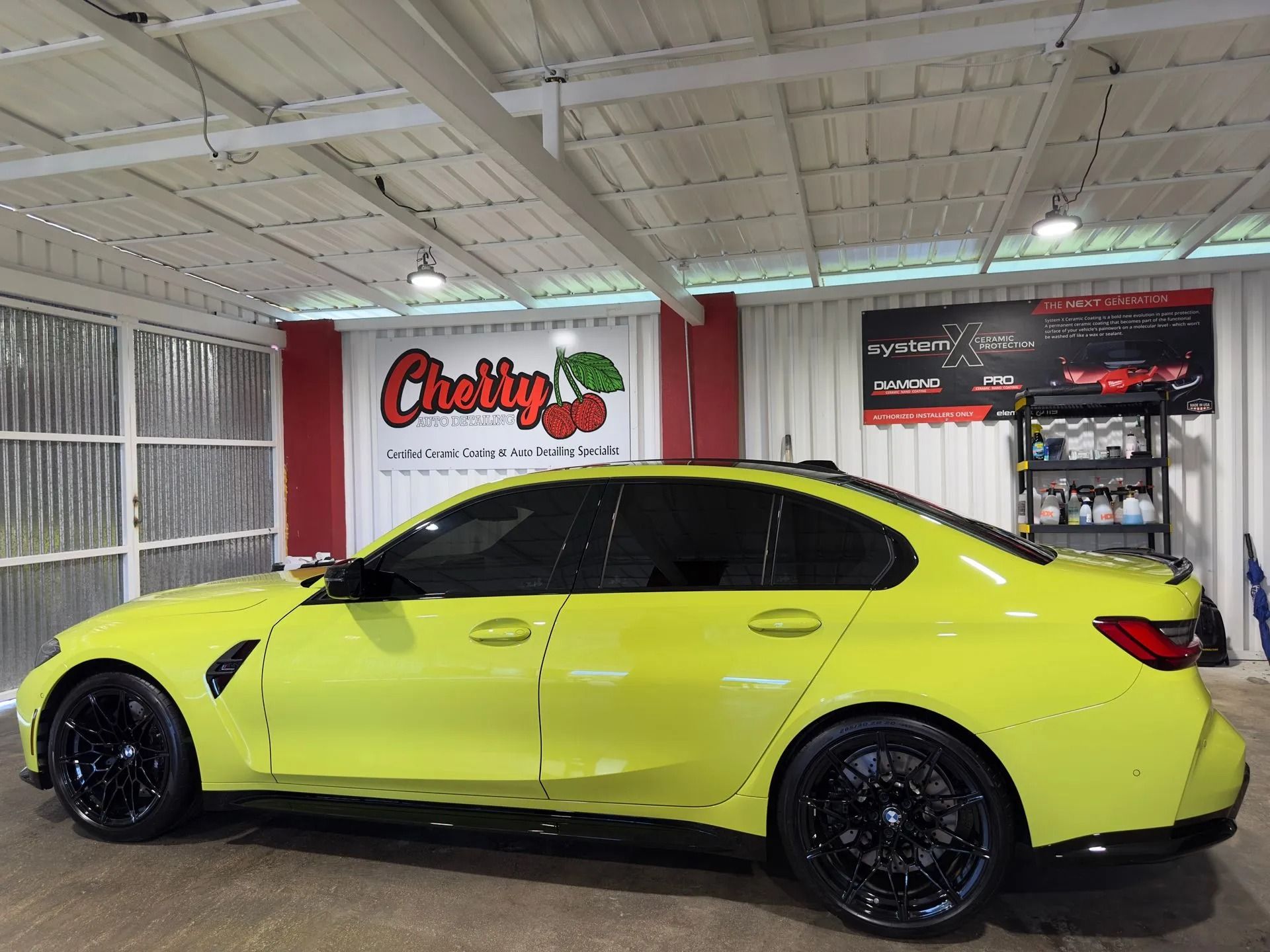 A bright yellow sedan parked inside a garage with a