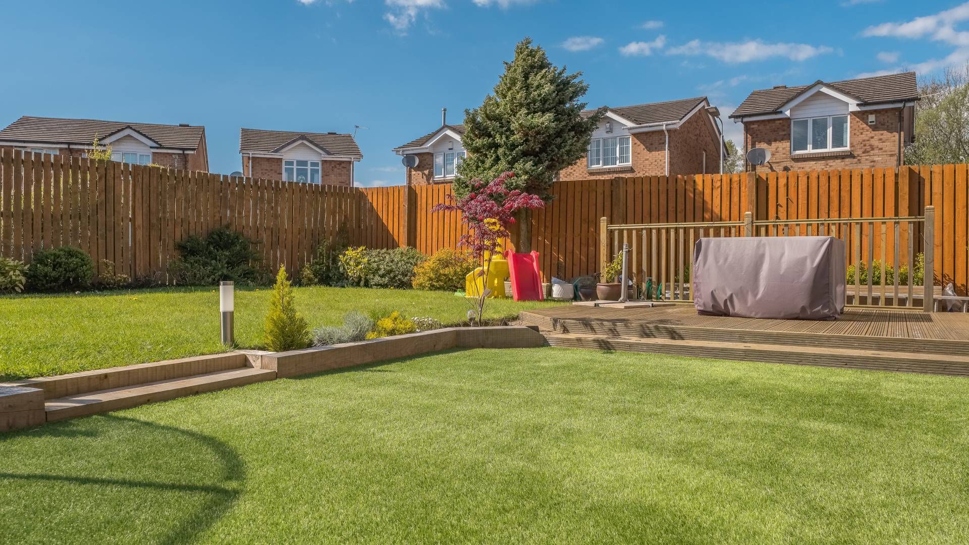 Lawn in a backyard with a wooden fence,  for privacy