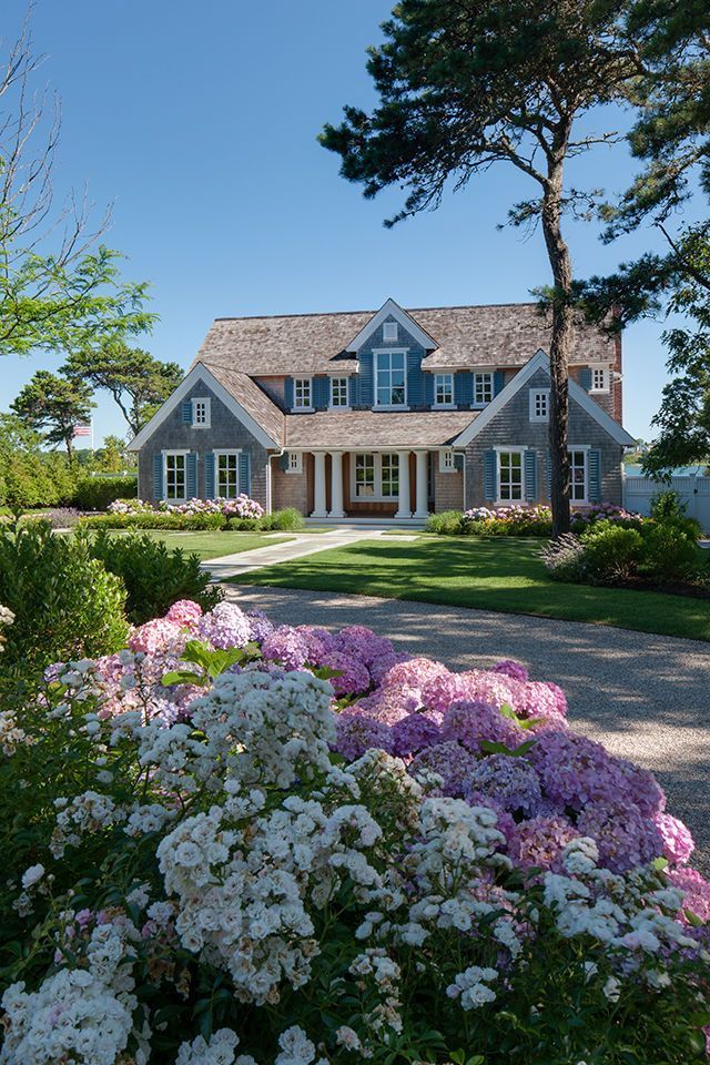 Beachside house with pool, green lawn, and blue sky
