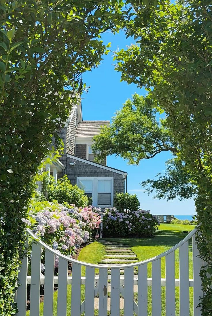 Beachside house with pool, green lawn, and blue sky