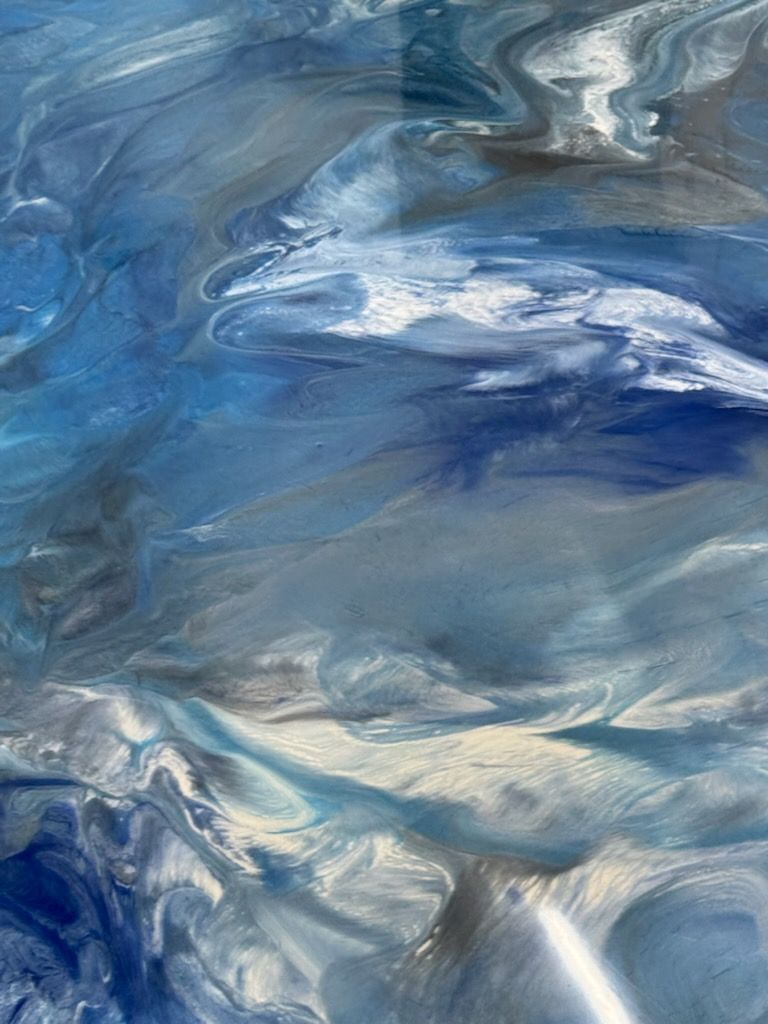 Abstract blue and white marbled texture with swirling, layered brush-like strokes