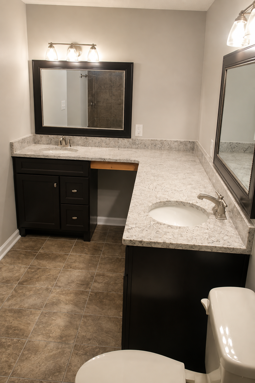 Empty bathroom vanity with speckled countertop, sink, mirror, and toilet in the foreground.